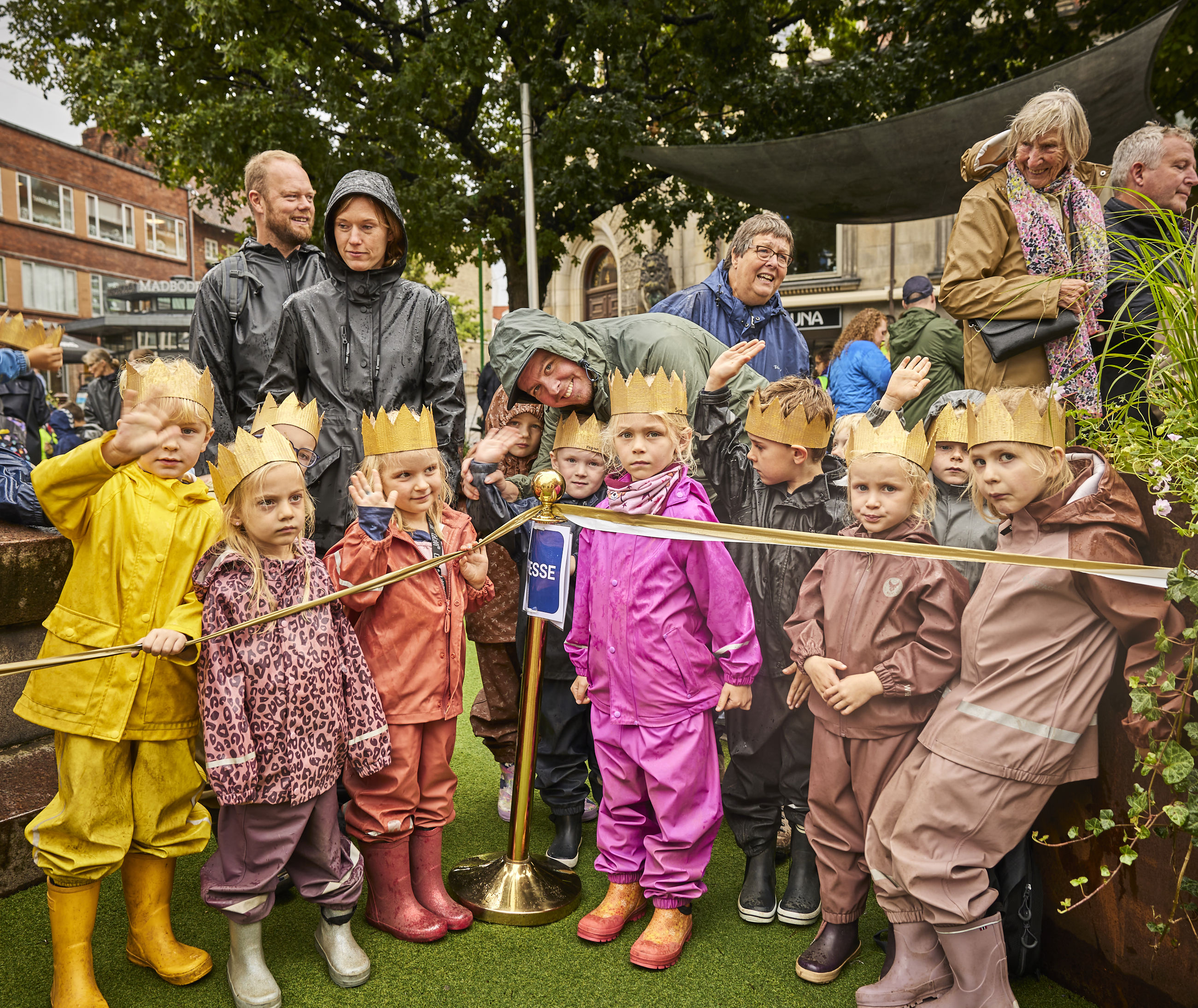 Børn med kroner på står klar til at modtage Dronningen på Rådhustorvet